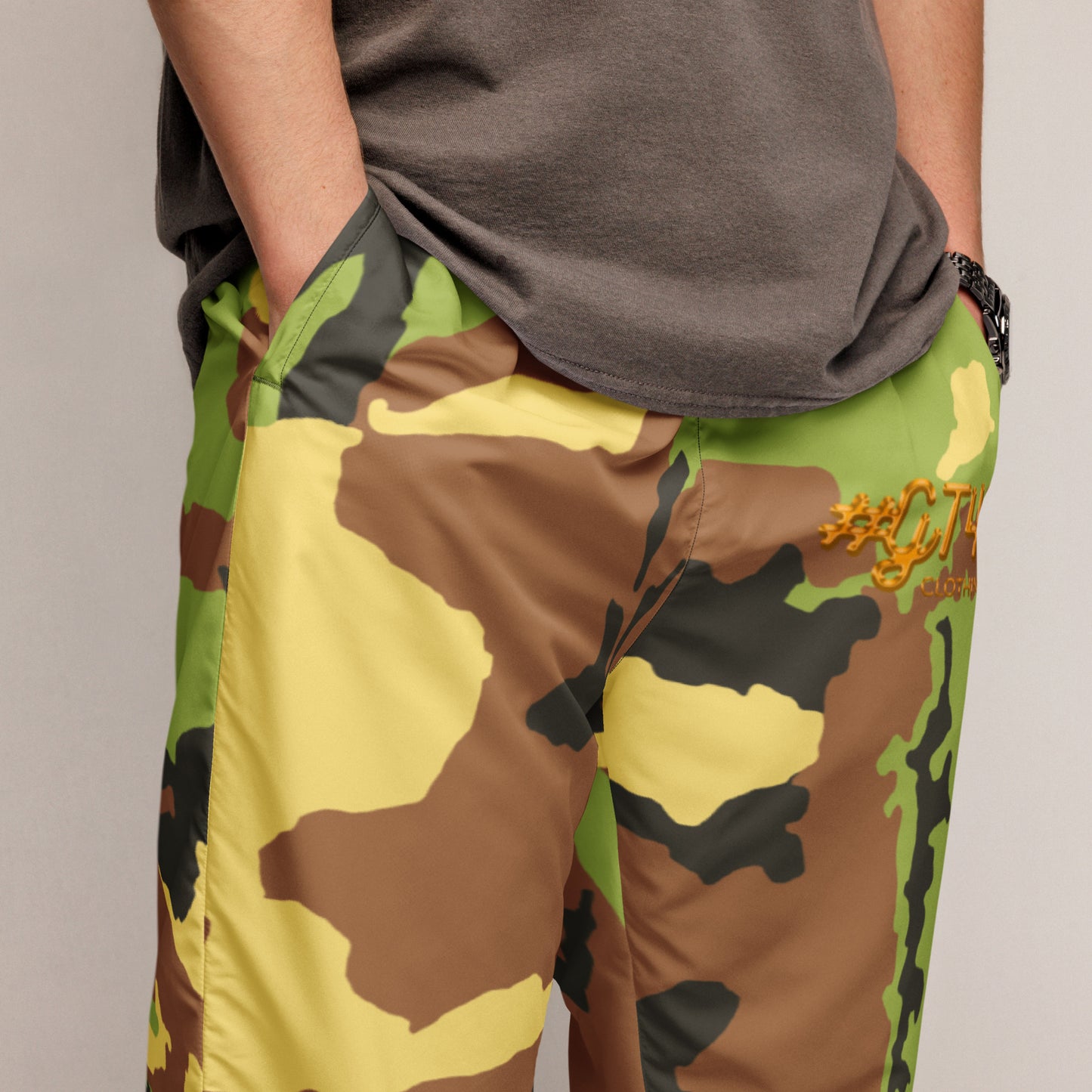 Camouflage pants with a brand logo on a neutral background