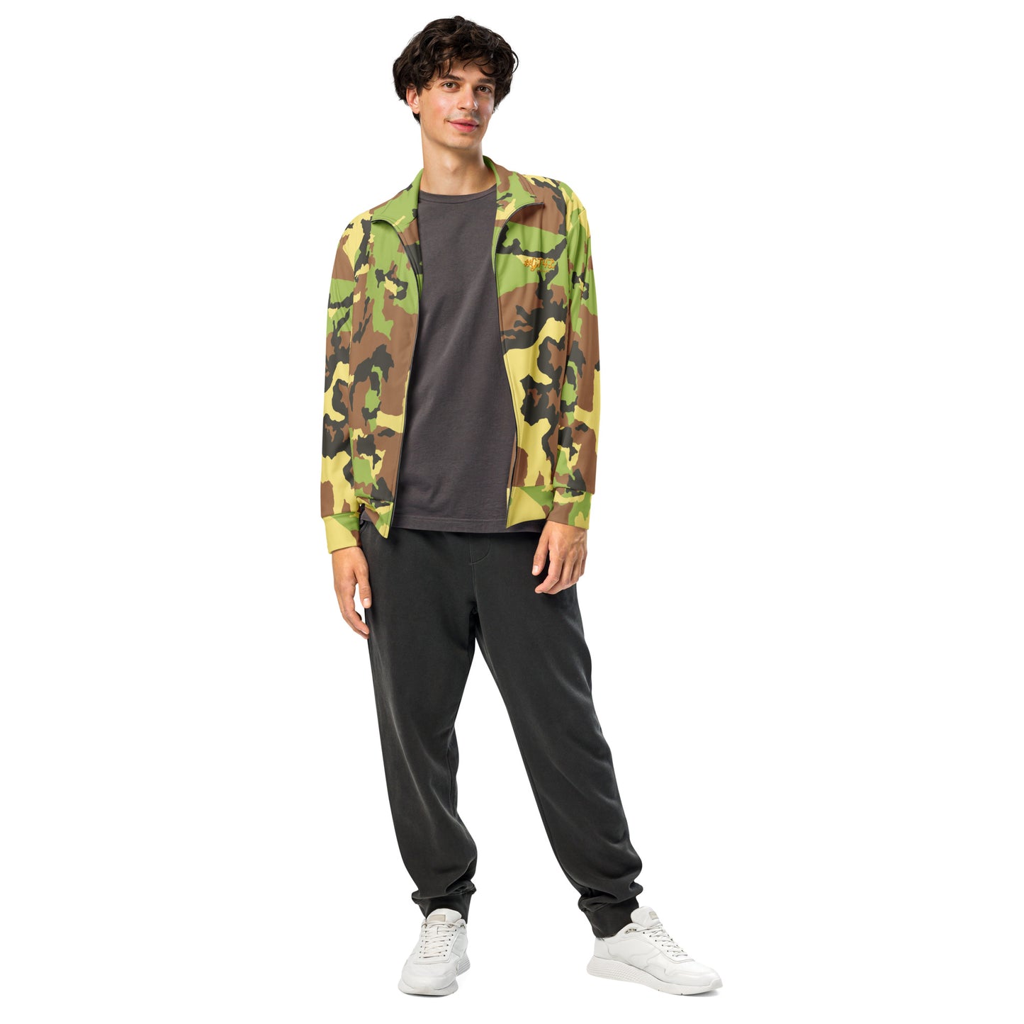 Person wearing a camouflage jacket, gray shirt, and black pants on a white background