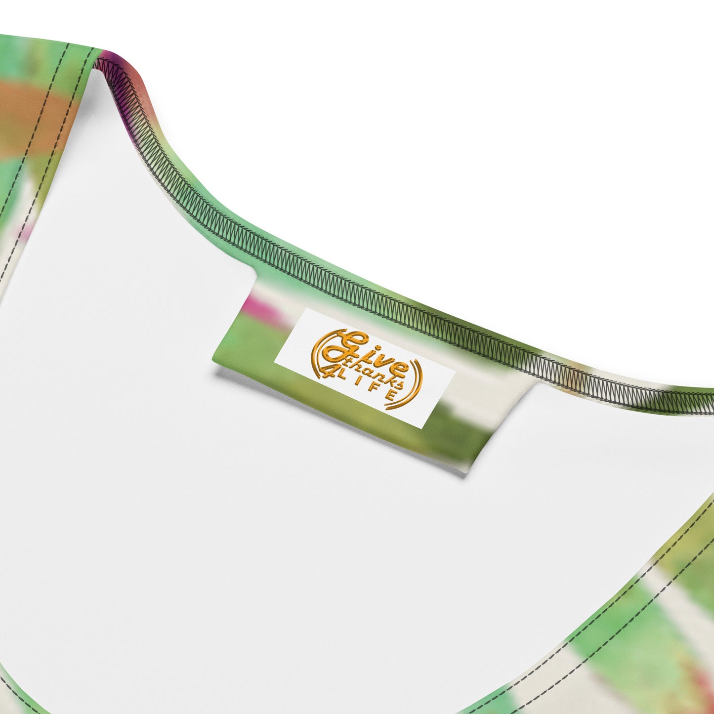 Close-up of a colorful bikini top with a brand label on a white background
