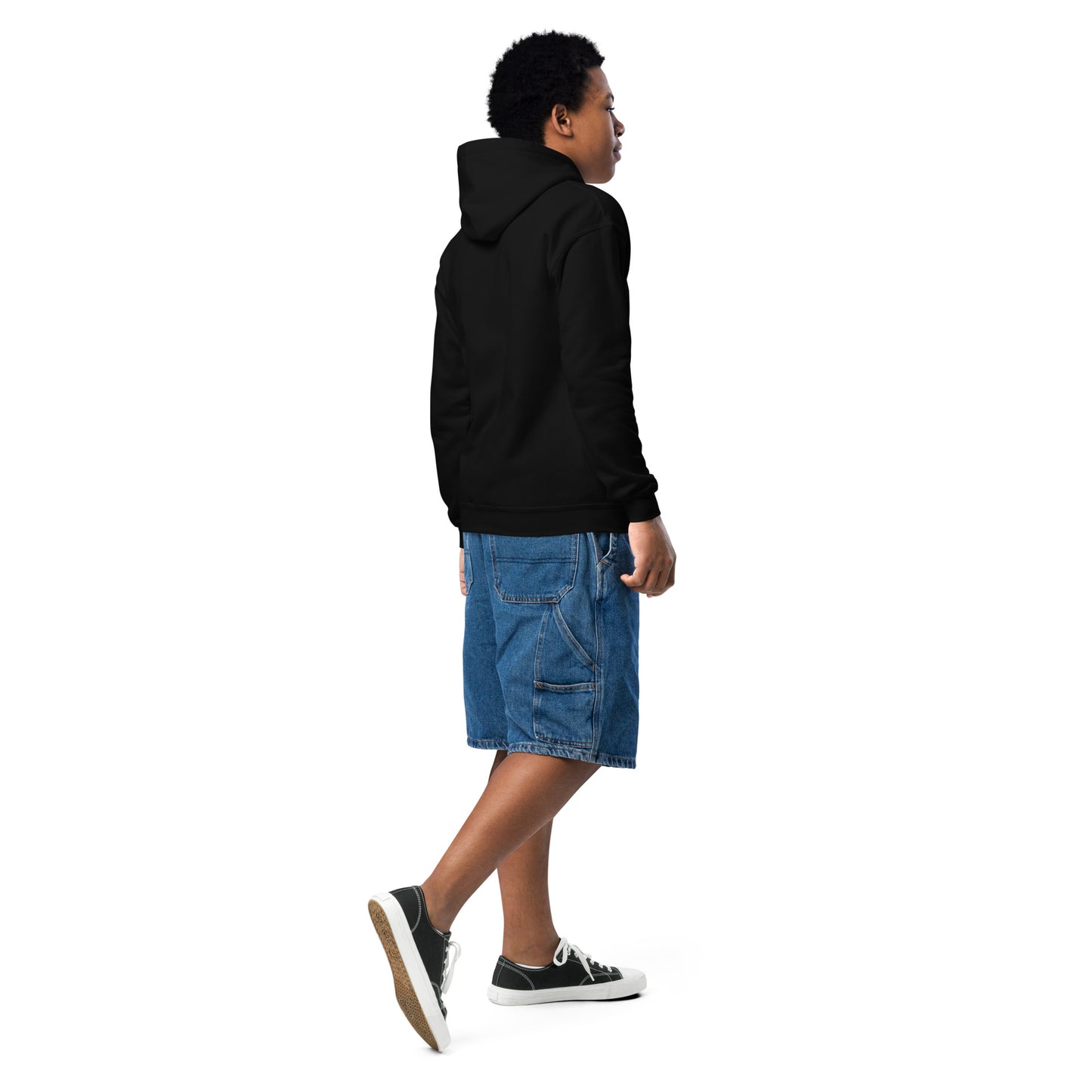 Person wearing a black hoodie and blue shorts on a white background
