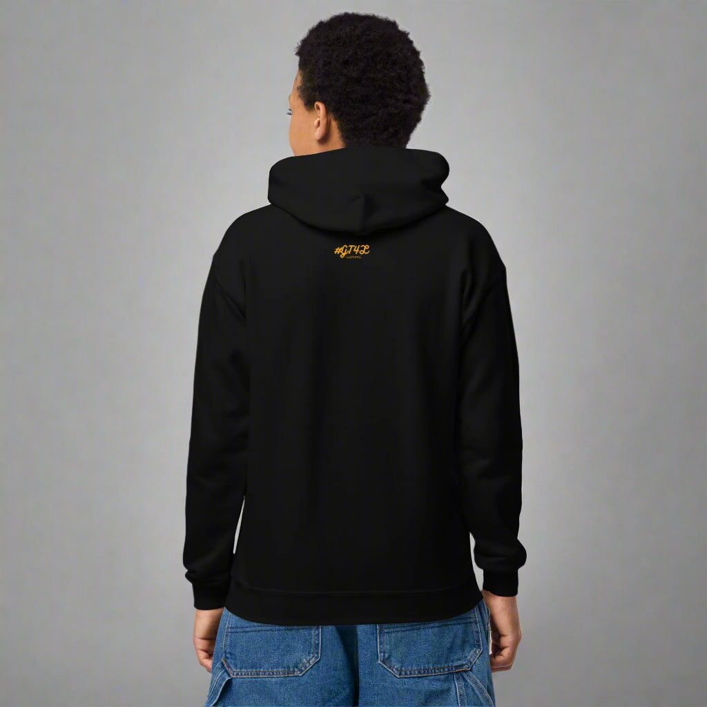 Person wearing a black hoodie with yellow text on the back, standing against a white background