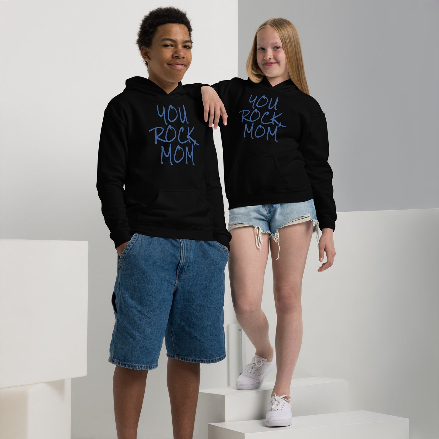 Two children wearing black hoodies with 'YOU ROCK MOM' text on a white background