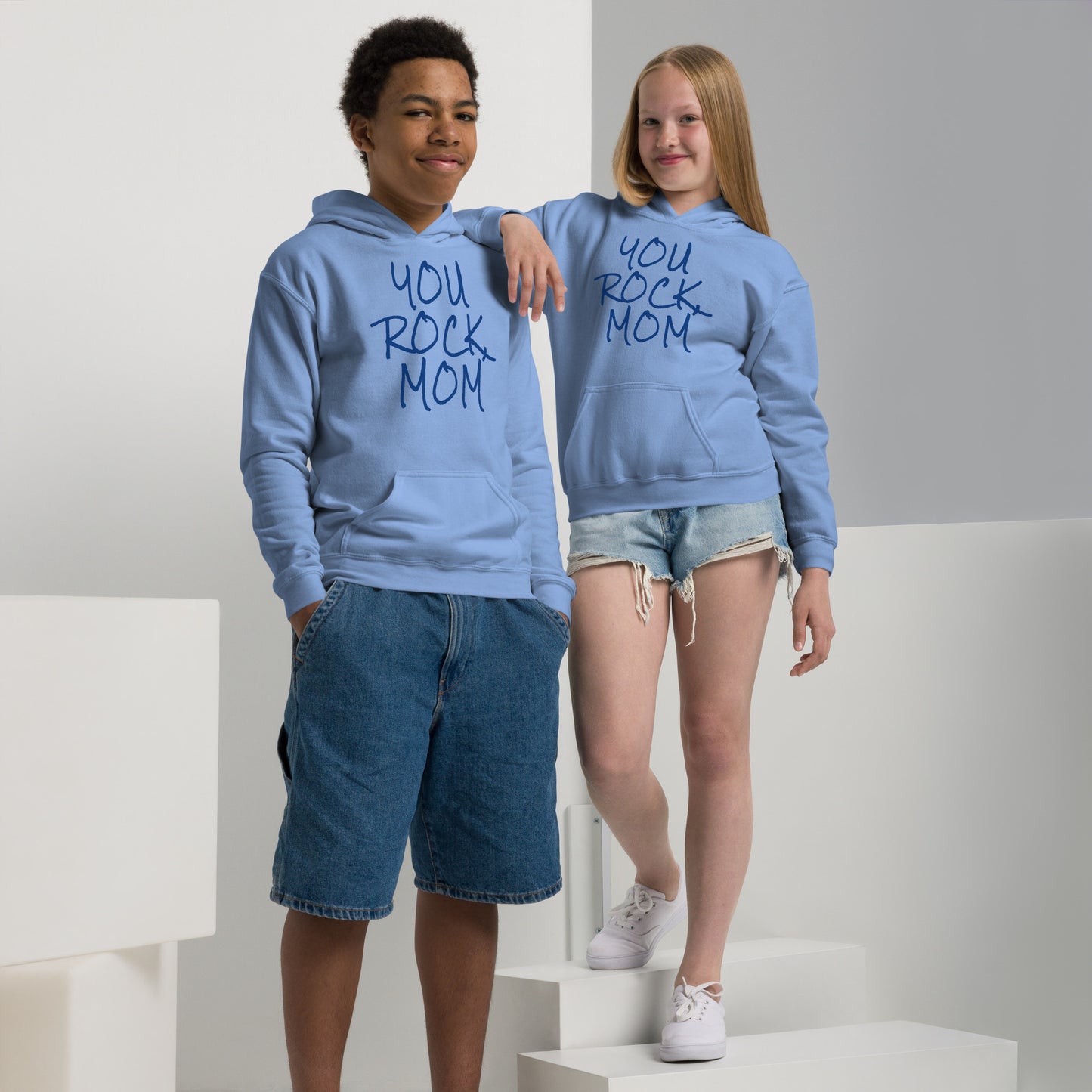 Two children wearing matching blue hoodies with 'You Rock Mom' text on a white background