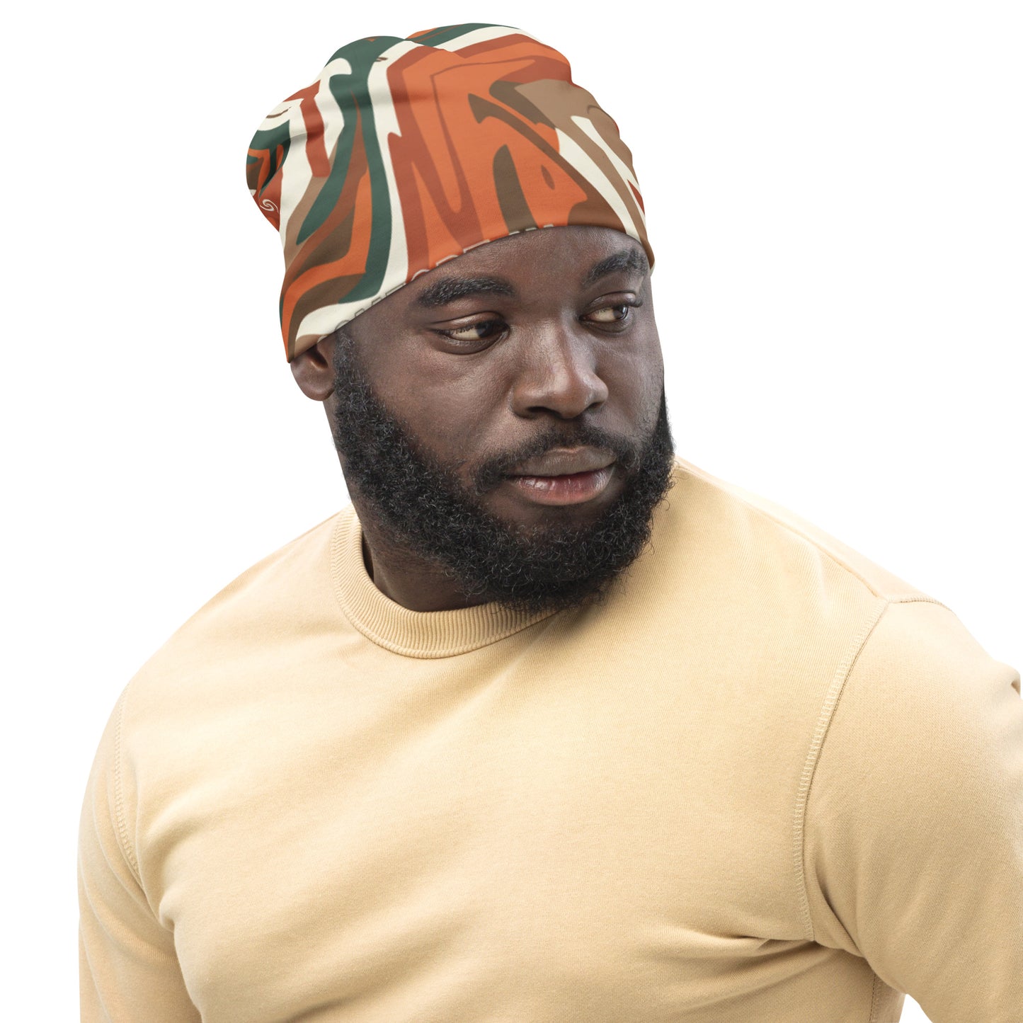 Man wearing a patterned headscarf and beige shirt on a white background