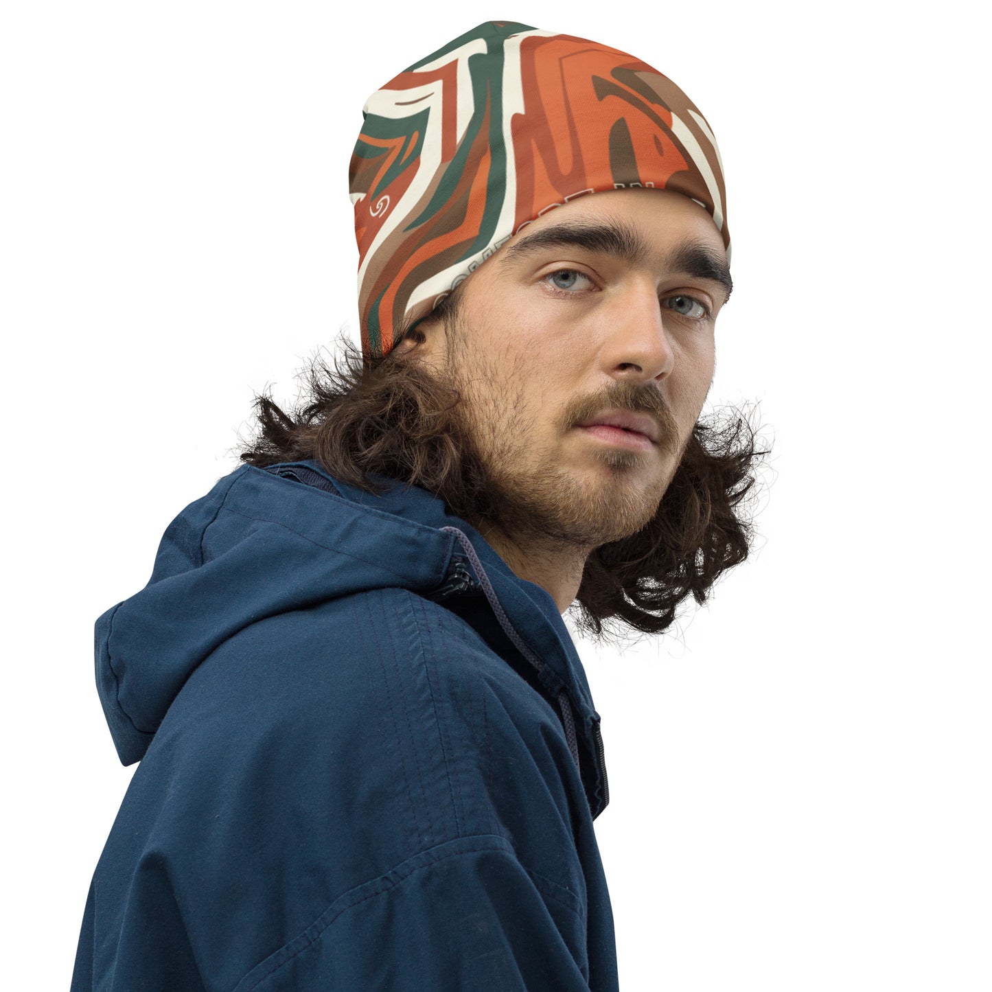 Man wearing a patterned headband and blue jacket on a white background
