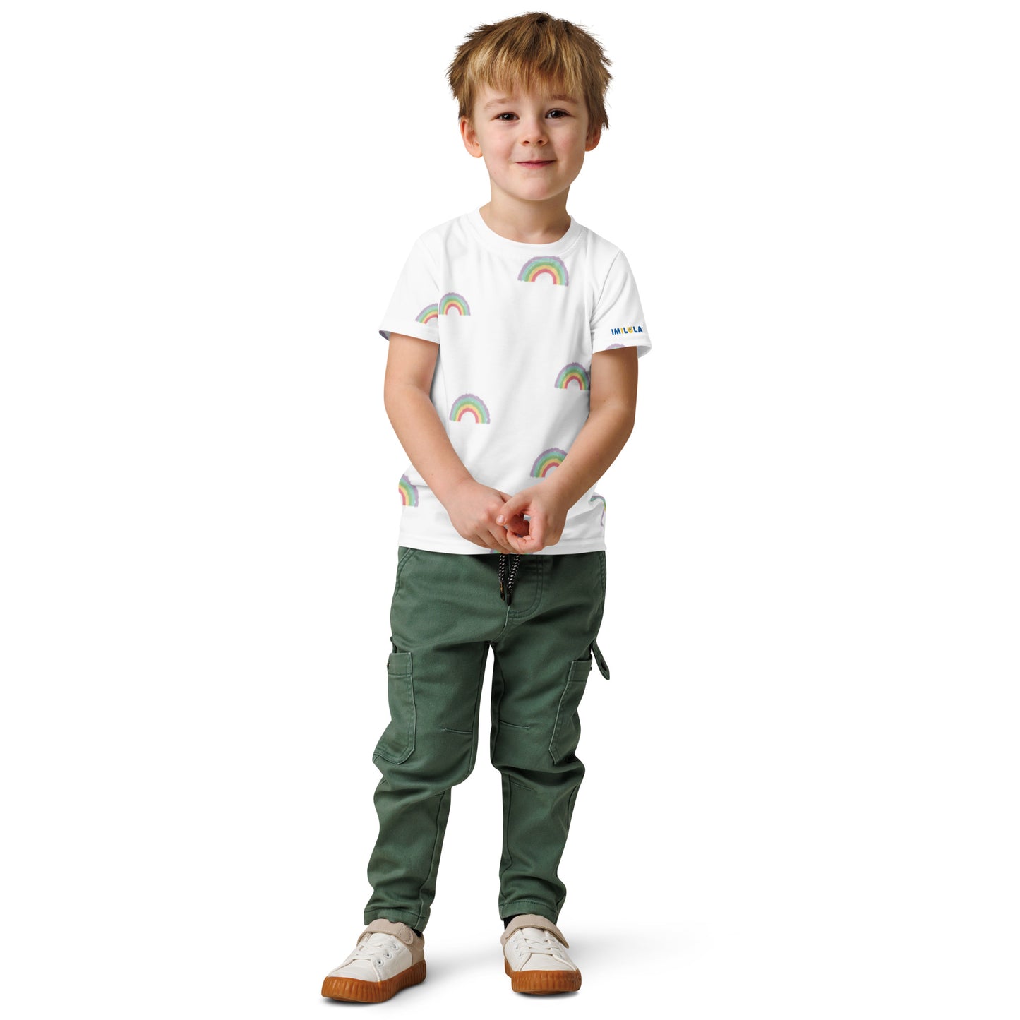 Child wearing a white t-shirt with colorful patterns and green pants on a white background
