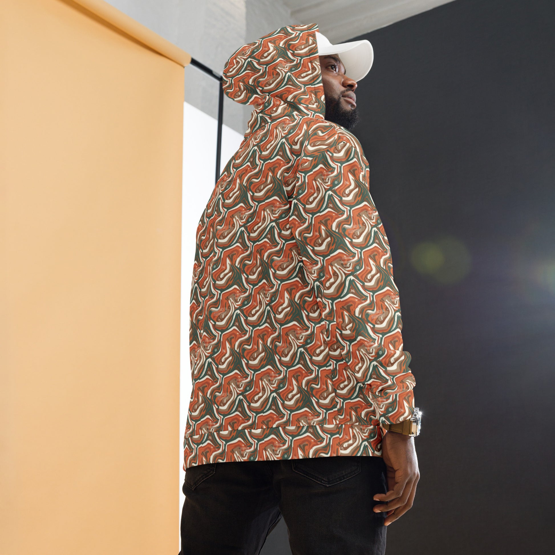 Person wearing a patterned raincoat standing against a building with a dark background
