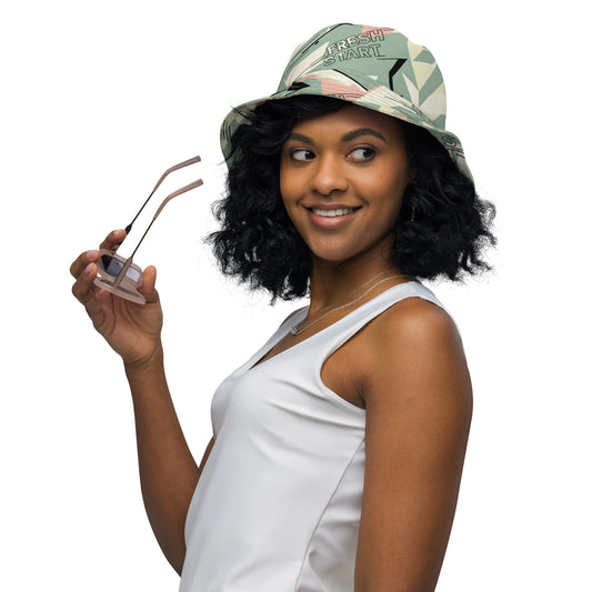 Woman wearing a white sleeveless top and colorful cap holding sunglasses on a white background