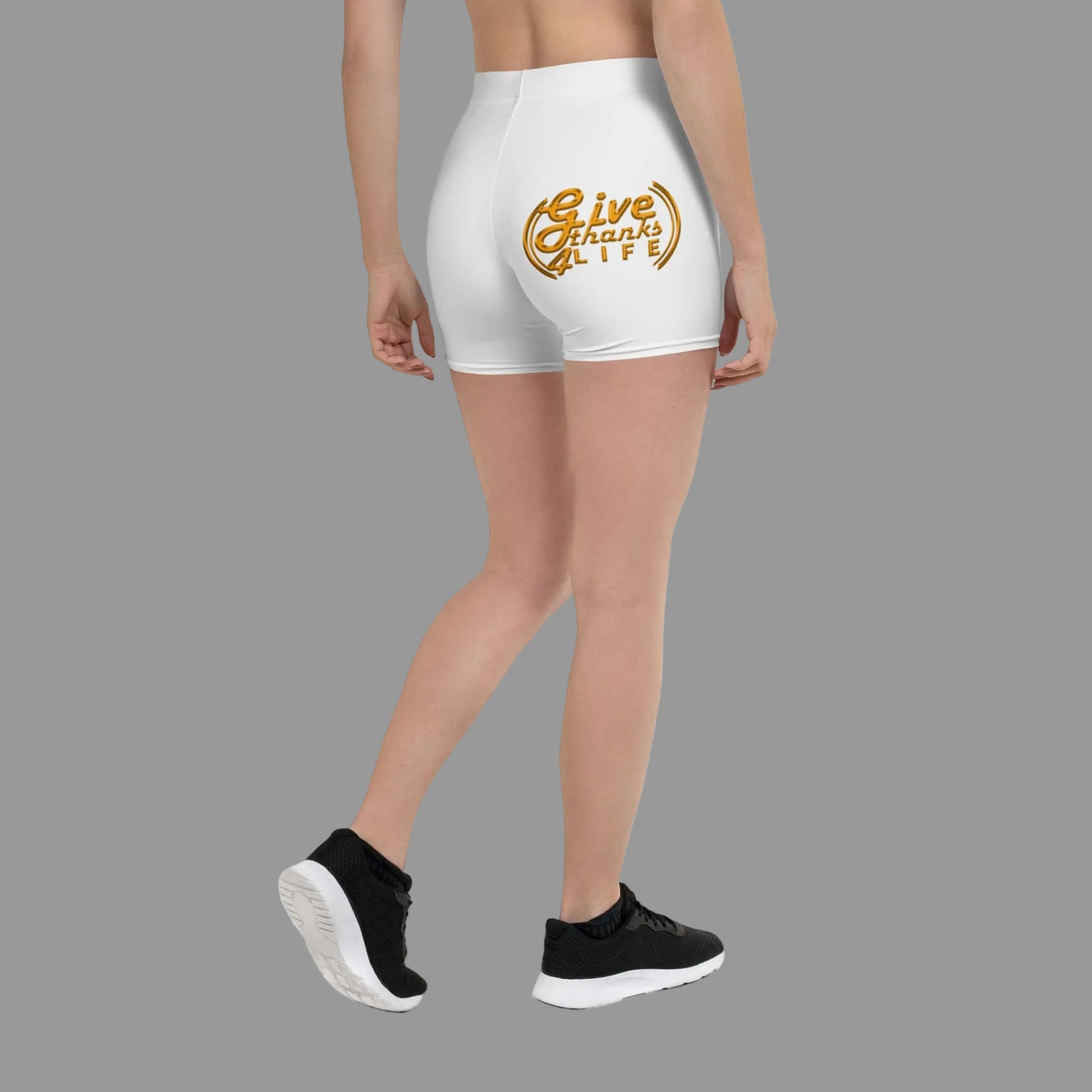 White shorts with 'Give Thanks' design worn by a person on a white background