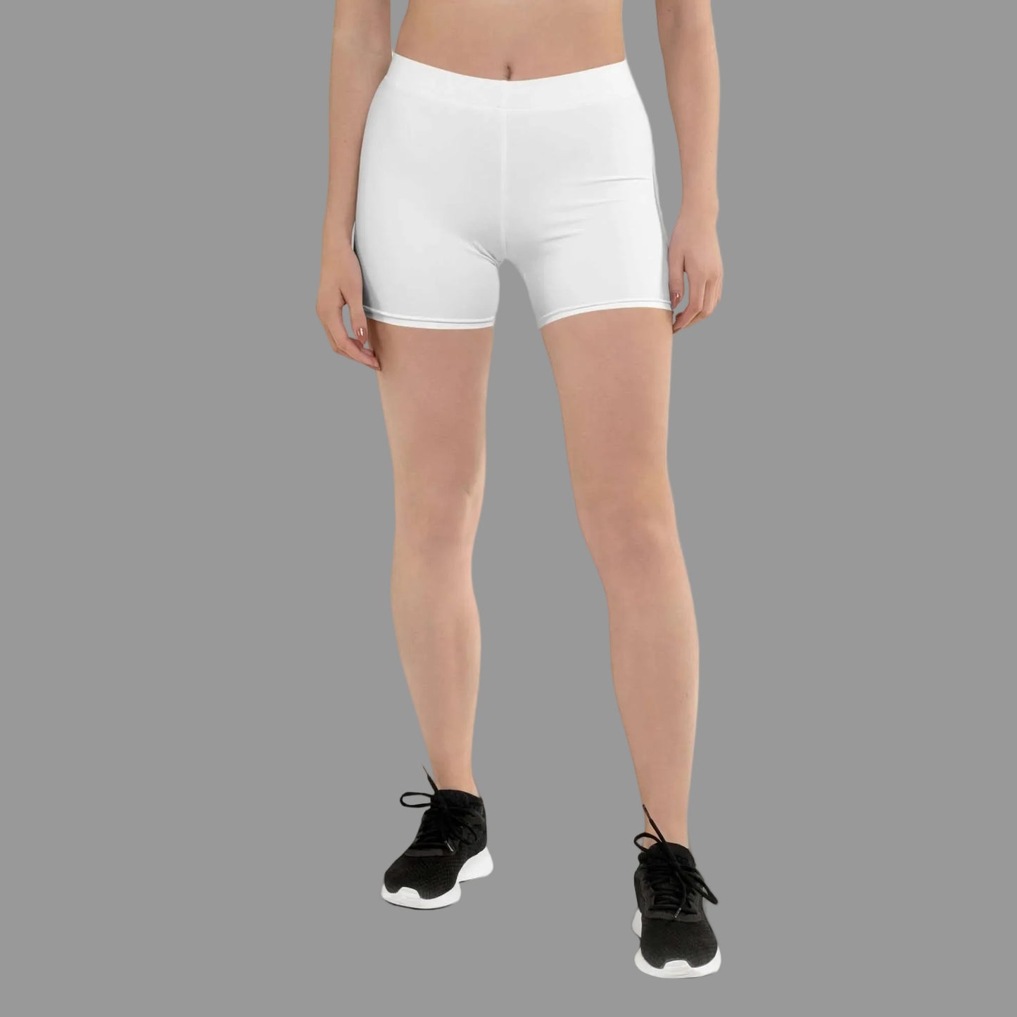 Person wearing white athletic shorts on a white background