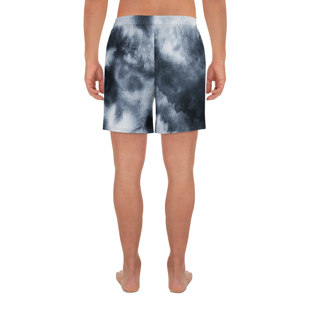 Person wearing black and white tie-dye shorts on a white background