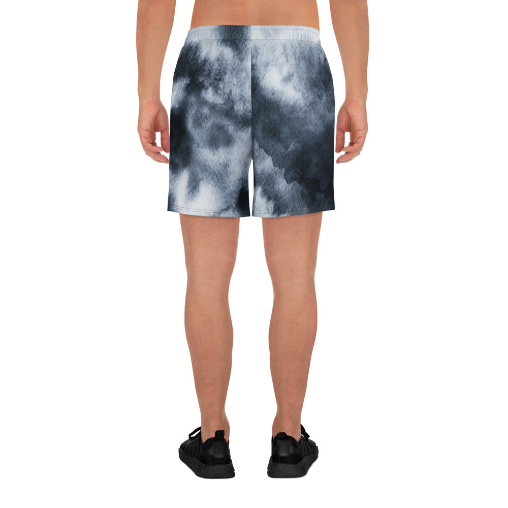 Person wearing black and white tie-dye shorts on a white background