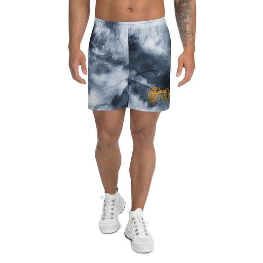 Person wearing tie-dye shorts with a logo on a white background