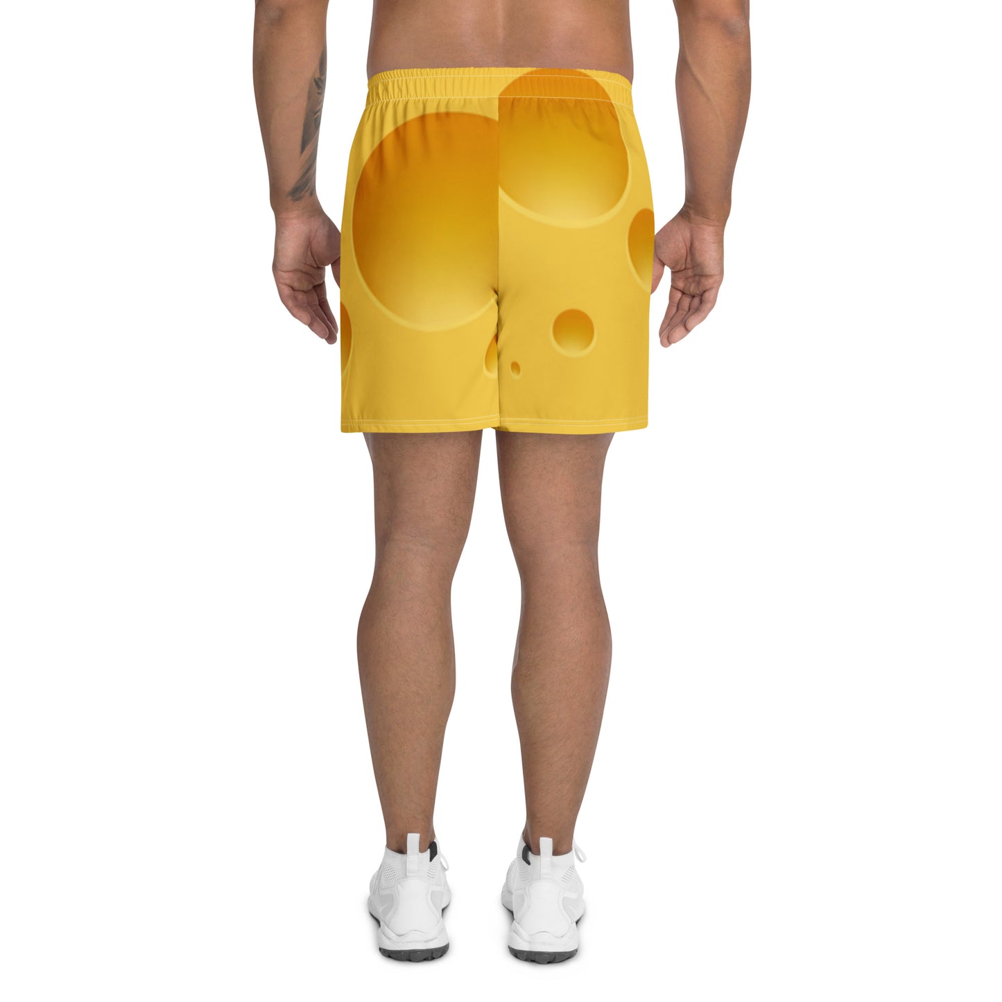 Yellow shorts worn by a person on a white background