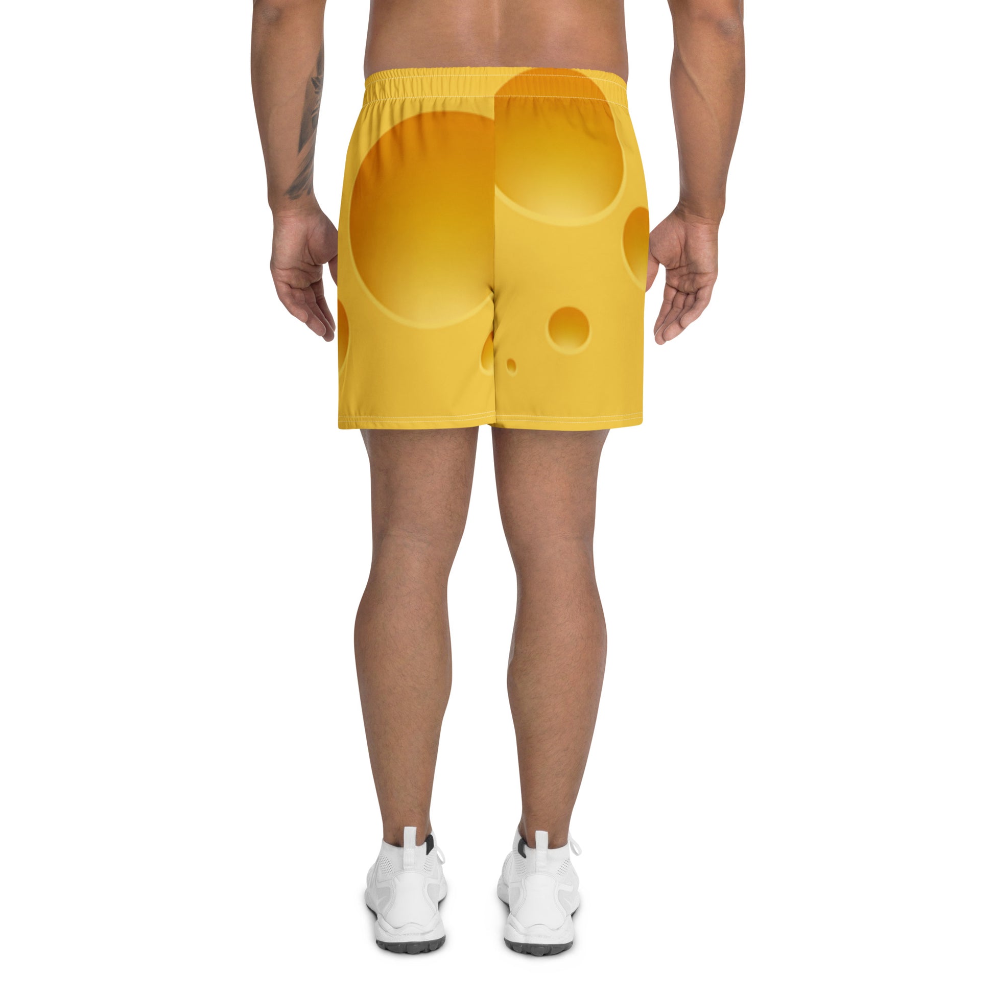 Yellow shorts worn by a person on a white background