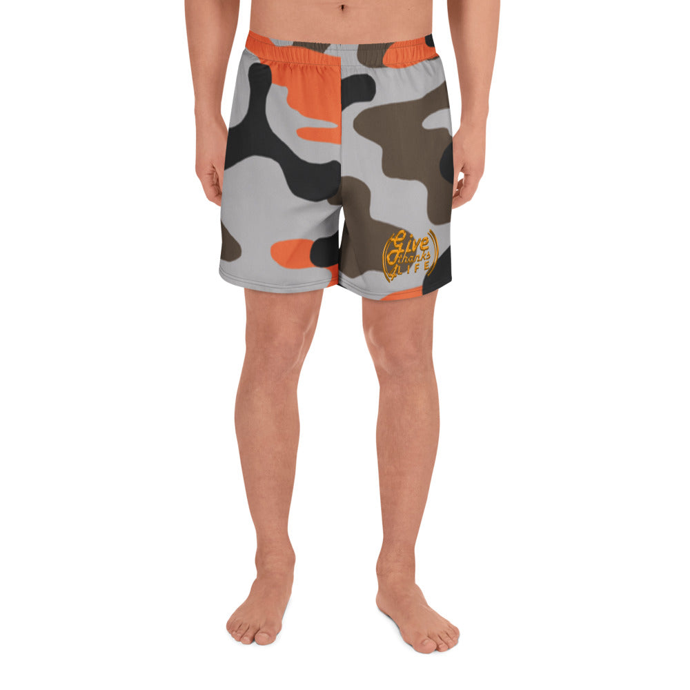 Camouflage-patterned shorts worn by a person on a white background