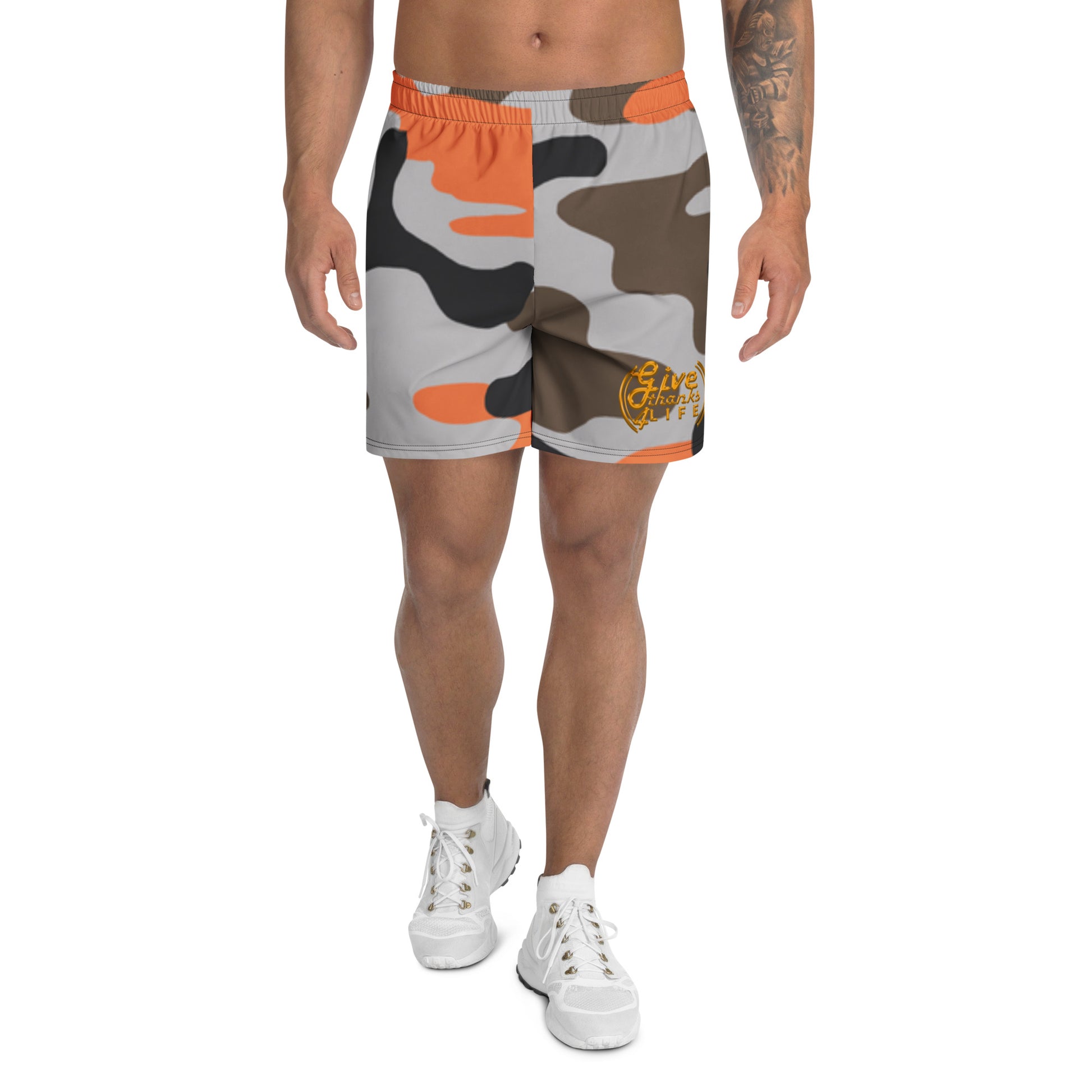 Person wearing camouflage shorts with orange accents on a white background