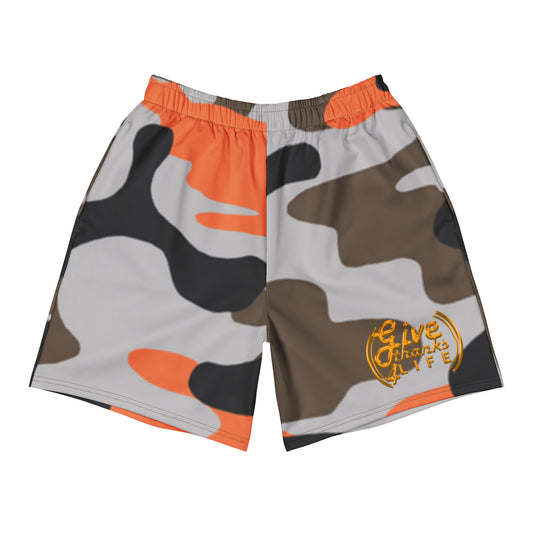 Camouflage shorts with orange accents and a logo on a white background