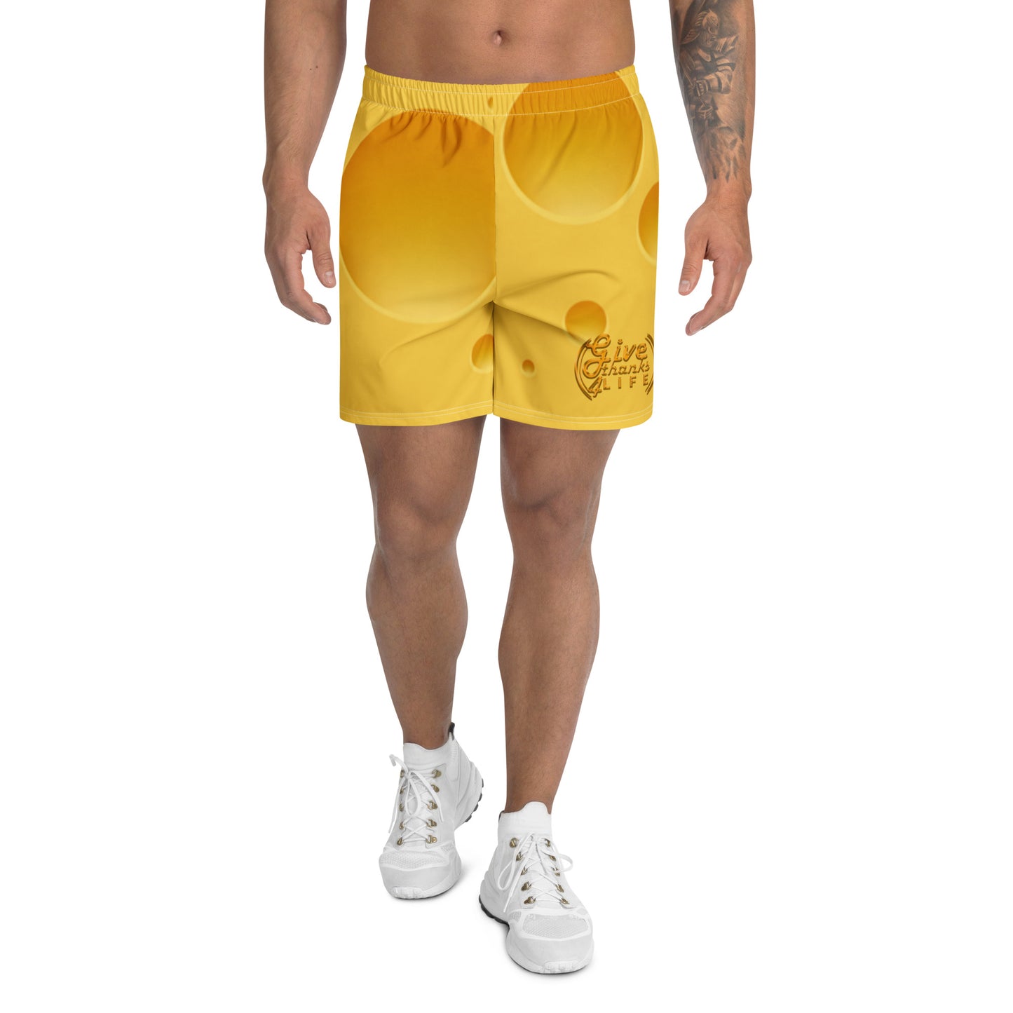 Person wearing yellow shorts with a logo on a white background