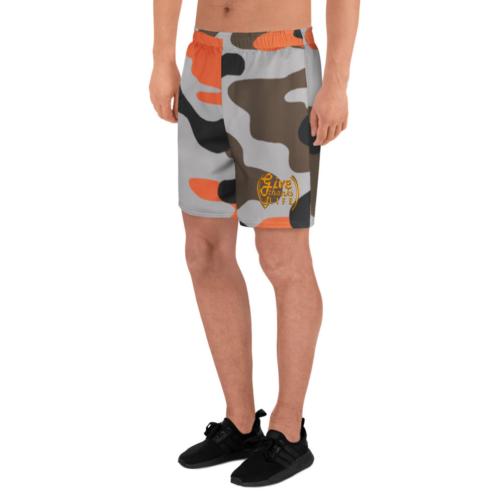 Camouflage-patterned shorts worn by a person on a white background