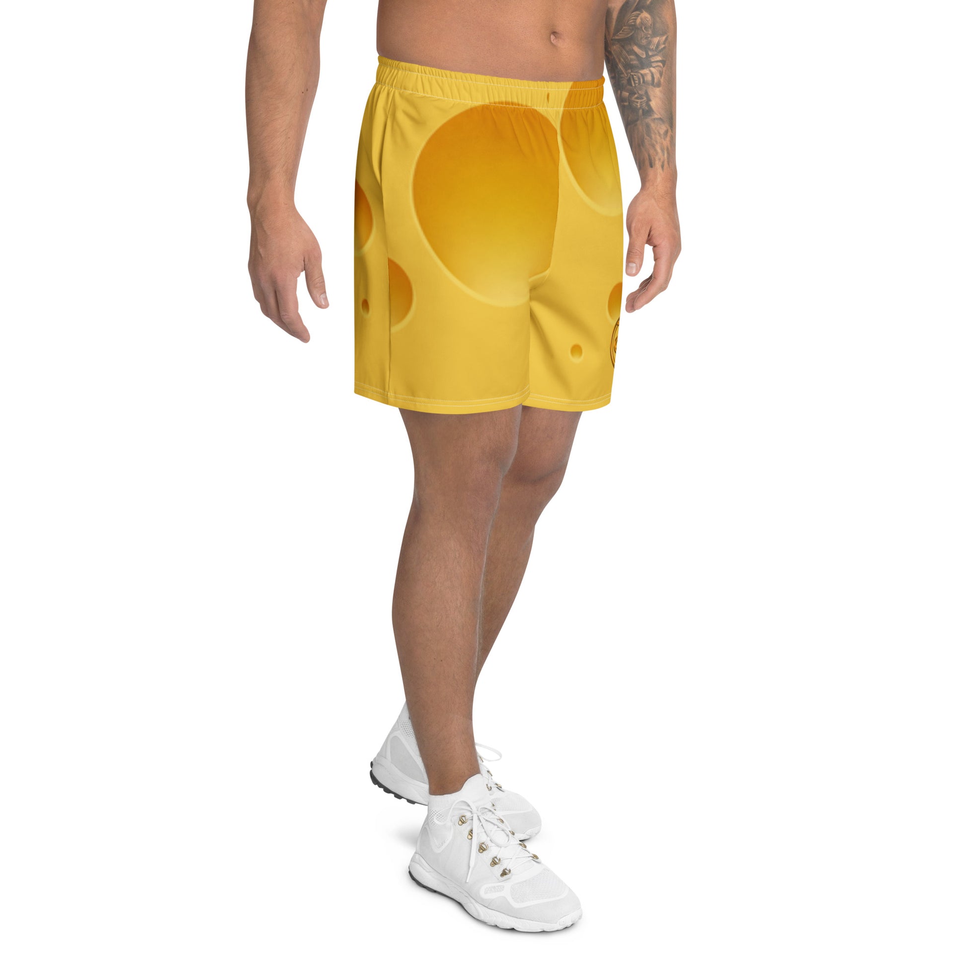 Person wearing bright yellow shorts with a unique pattern on a white background