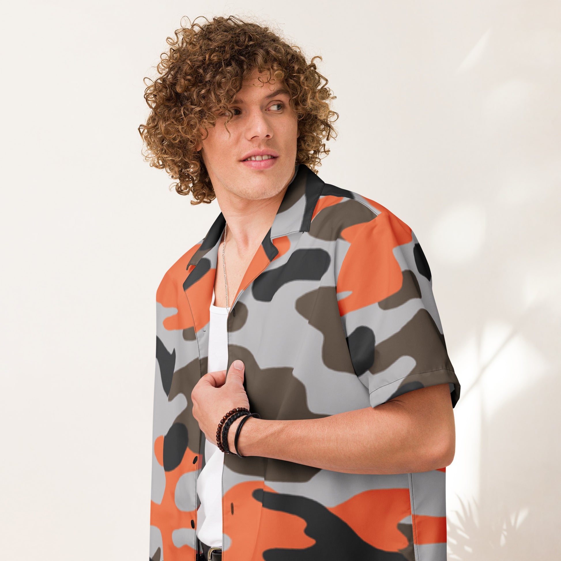 Person wearing a camouflage-patterned shirt with orange, gray, and black colors on a white background