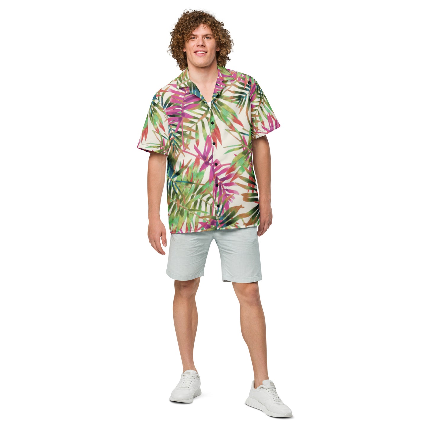 Person wearing a colorful tropical shirt and white shorts on a white background