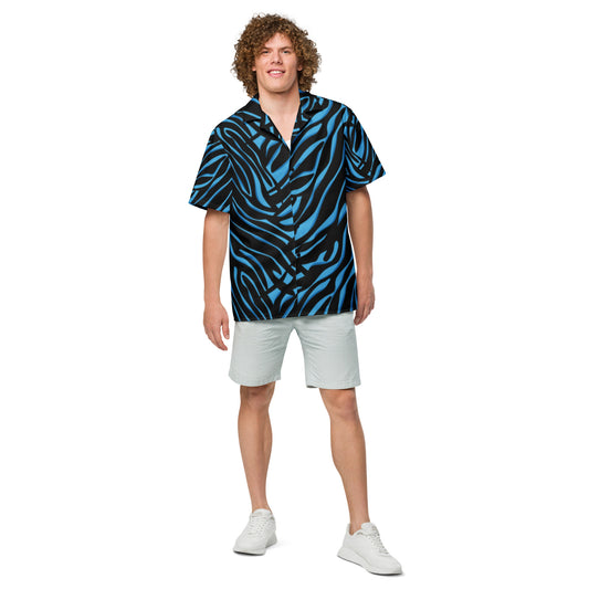 Man wearing a patterned black and gray shirt with light gray shorts on a white background