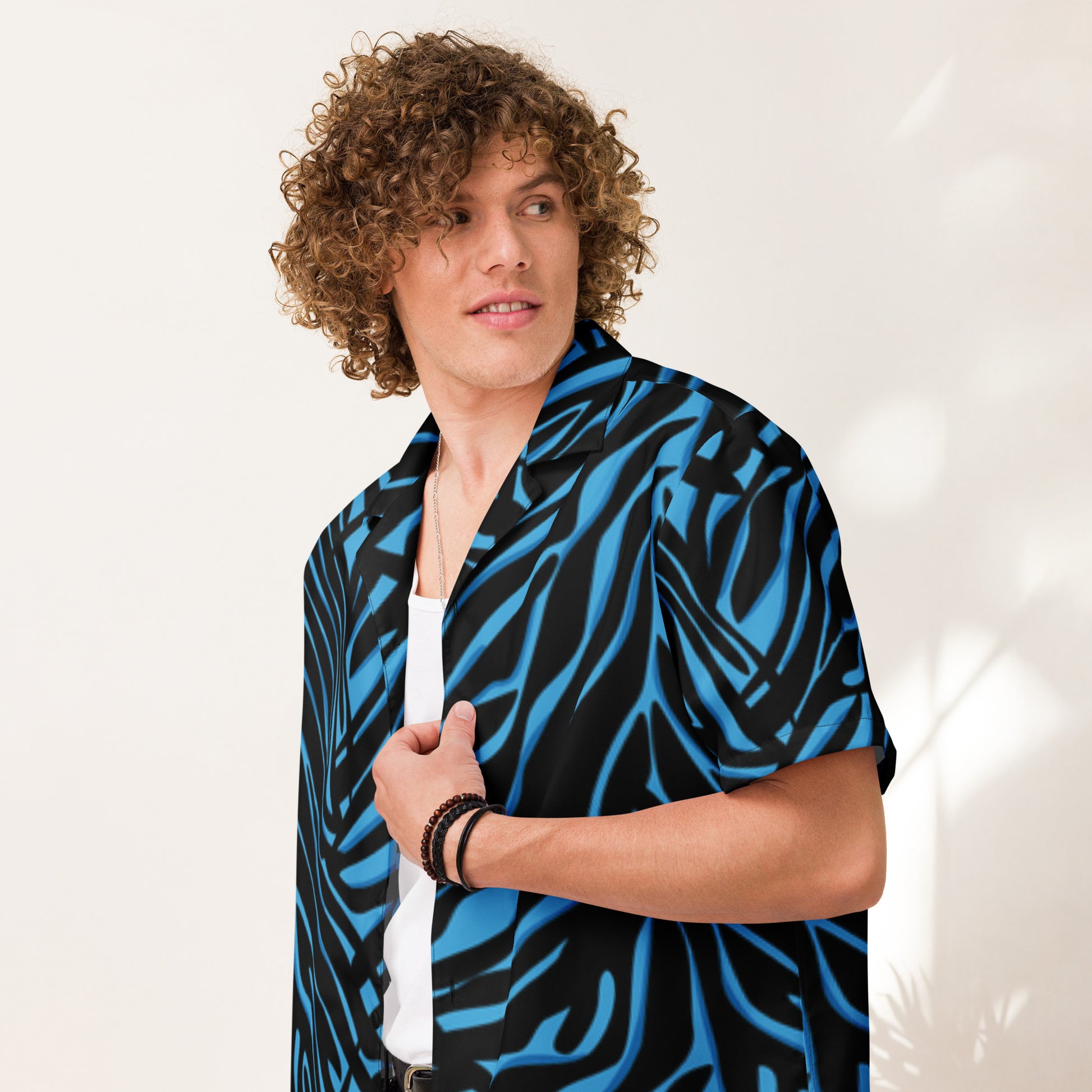 Person wearing a blue and black patterned shirt against a white background