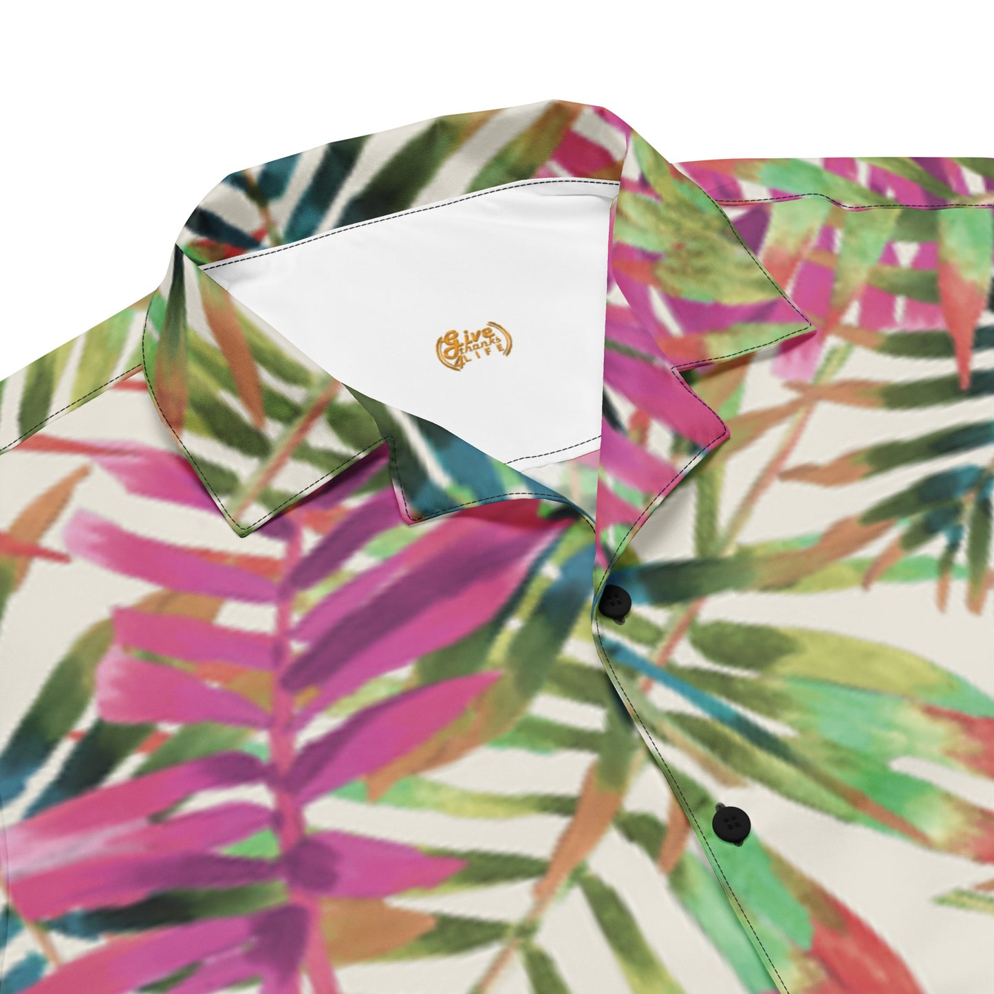 Colorful tropical leaf pattern shirt with a brand logo on a white background