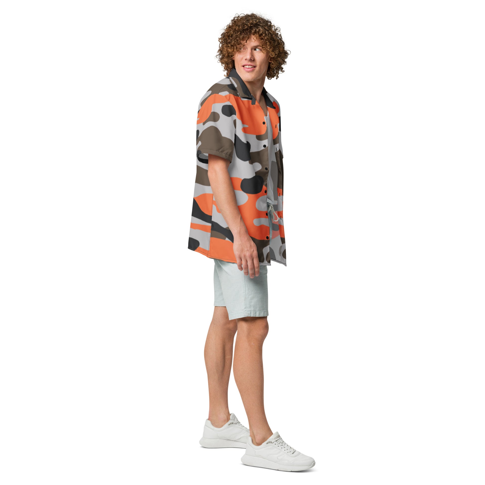 Person wearing a colorful patterned shirt and light shorts on a white background