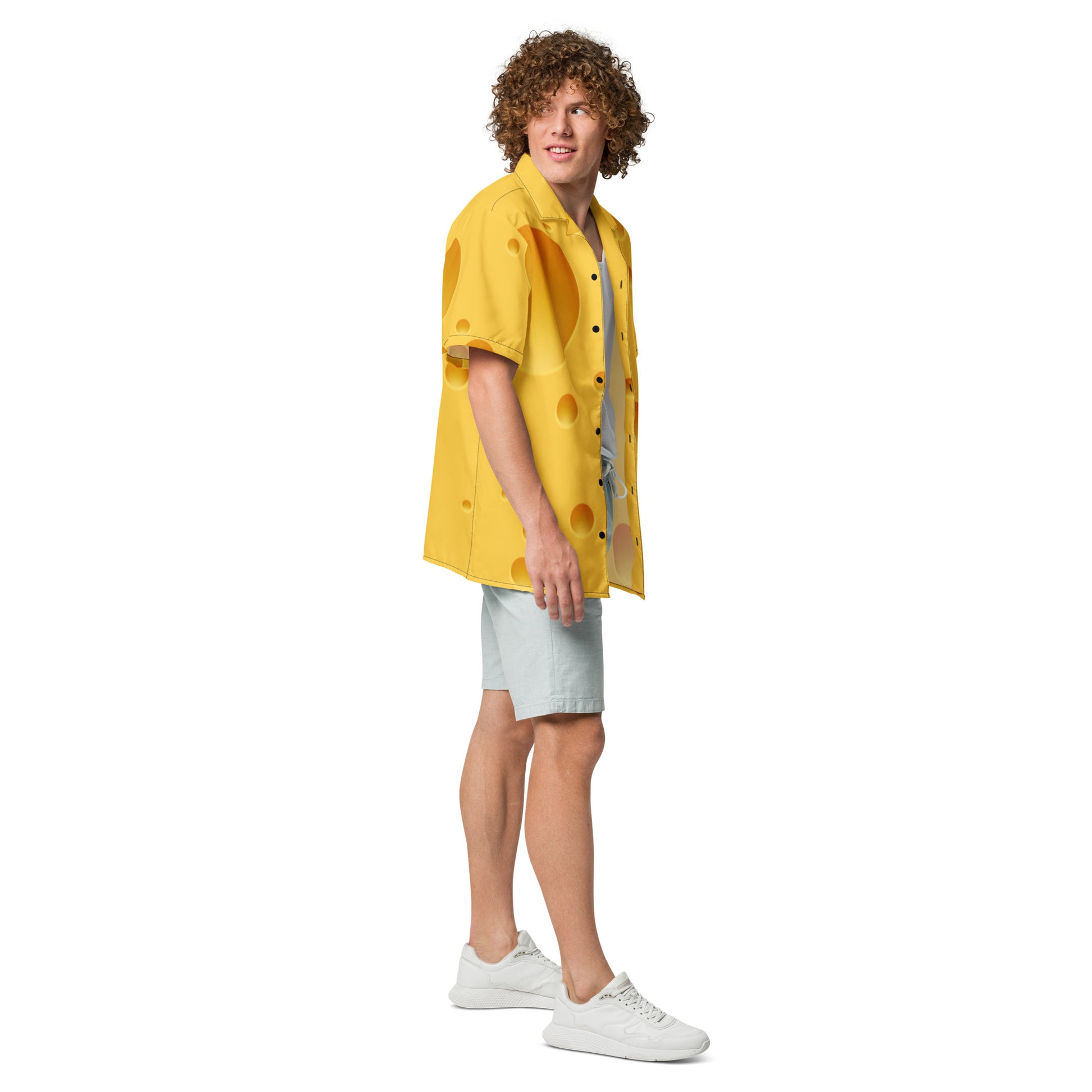 Person wearing a yellow shirt with black buttons, light gray shorts, and white sneakers on a white background