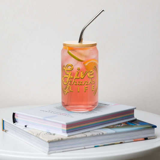 Pink drink in a mason jar with 'Give Thanks Life' text on a stack of books.