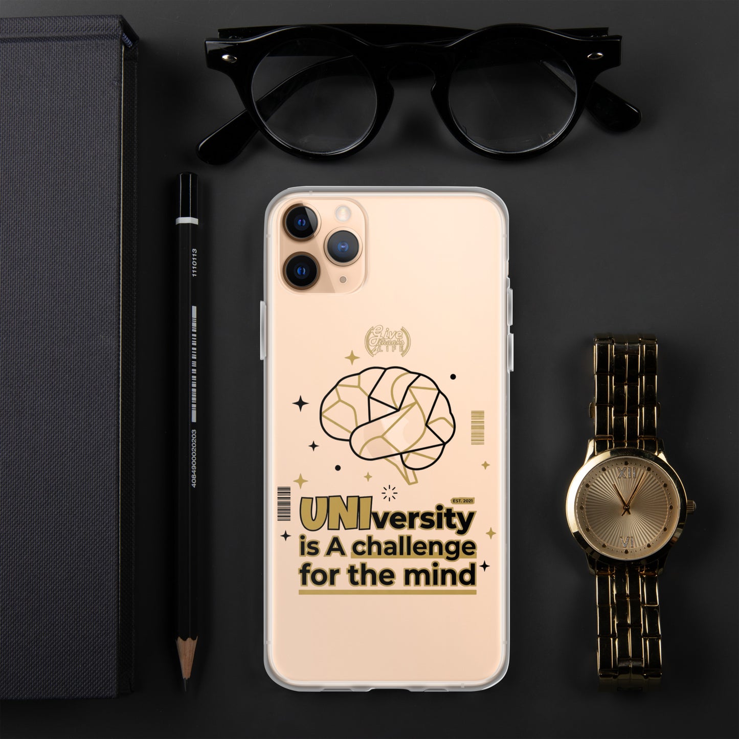 Phone case with motivational quote on a dark surface with accessories