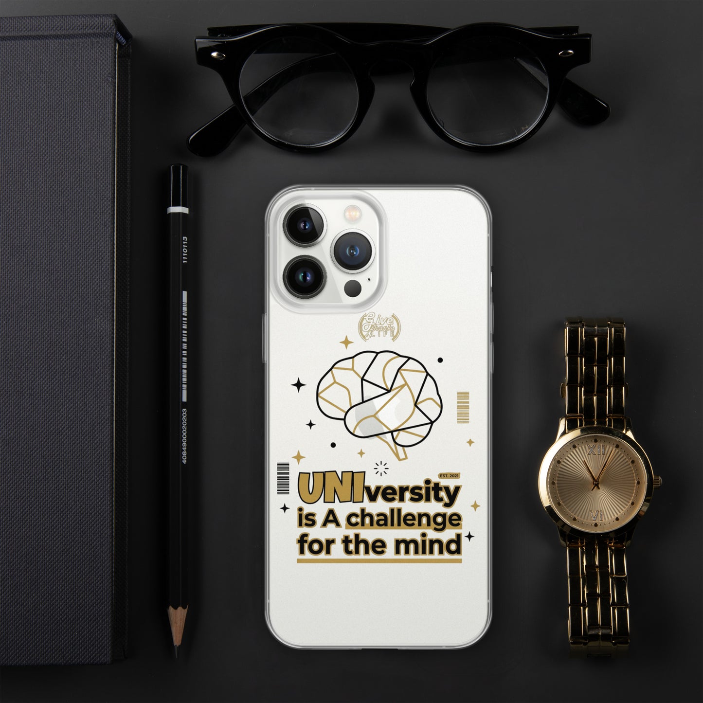 Phone case with brain design and text on a dark surface with glasses, pen, and watch.