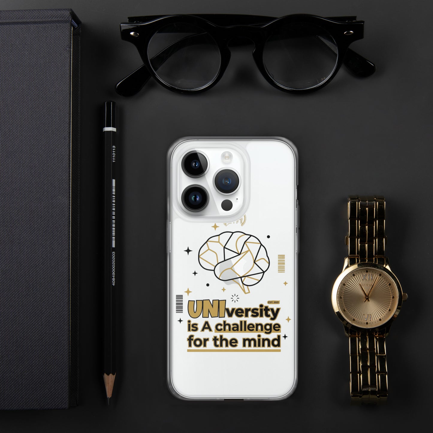 Phone case with 'UNI'versity is a challenge for the mind design on a dark surface with glasses, pen, and watch.