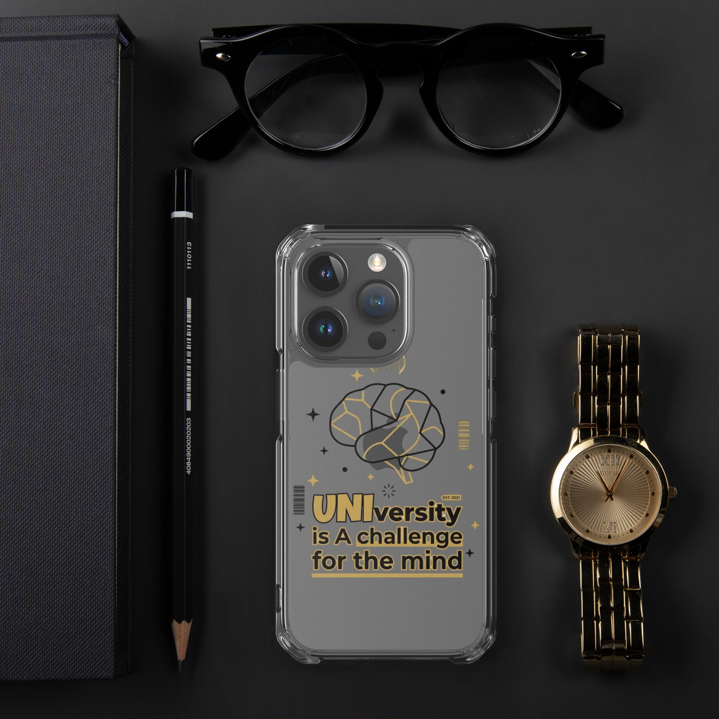 Phone case with 'UNIversity is A challenge for the mind' text on a dark surface with glasses, pen, and watch.