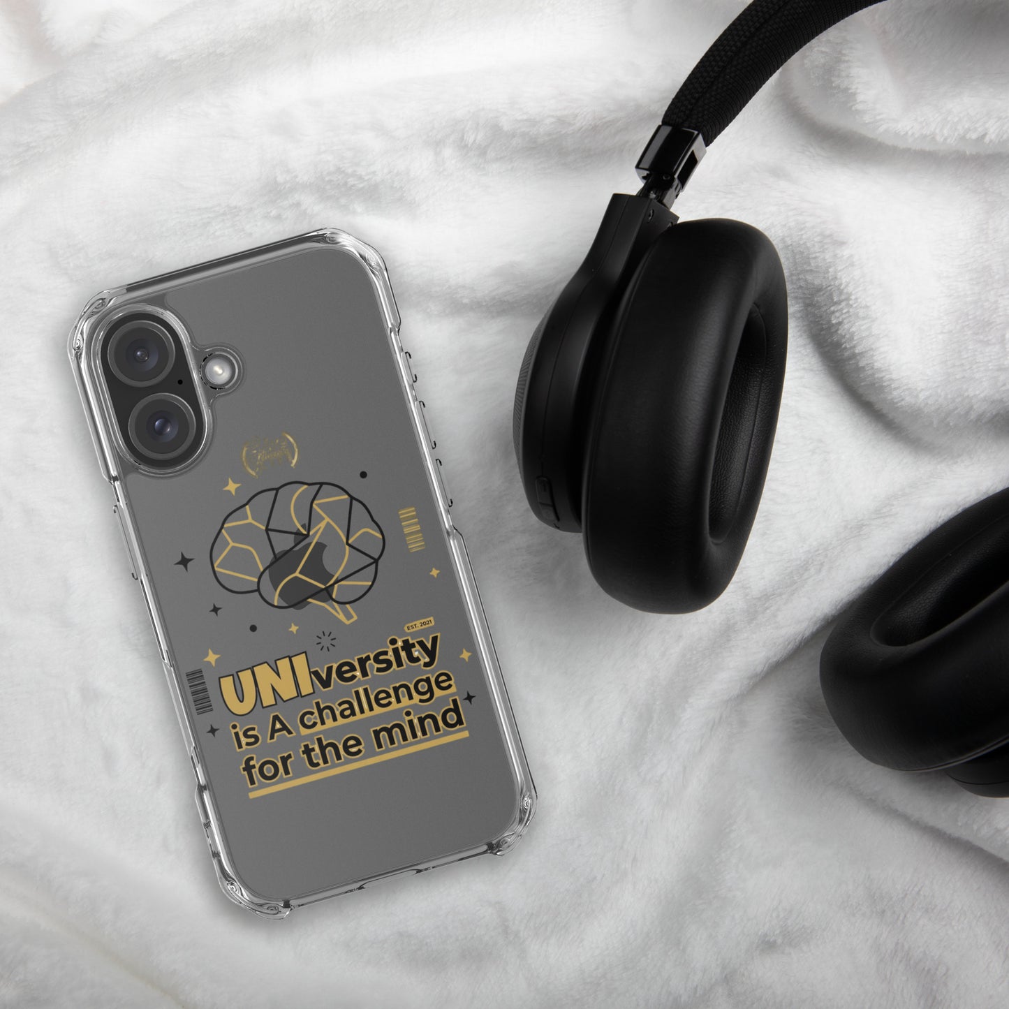 Phone case with geometric pattern next to black headphones on a marble surface