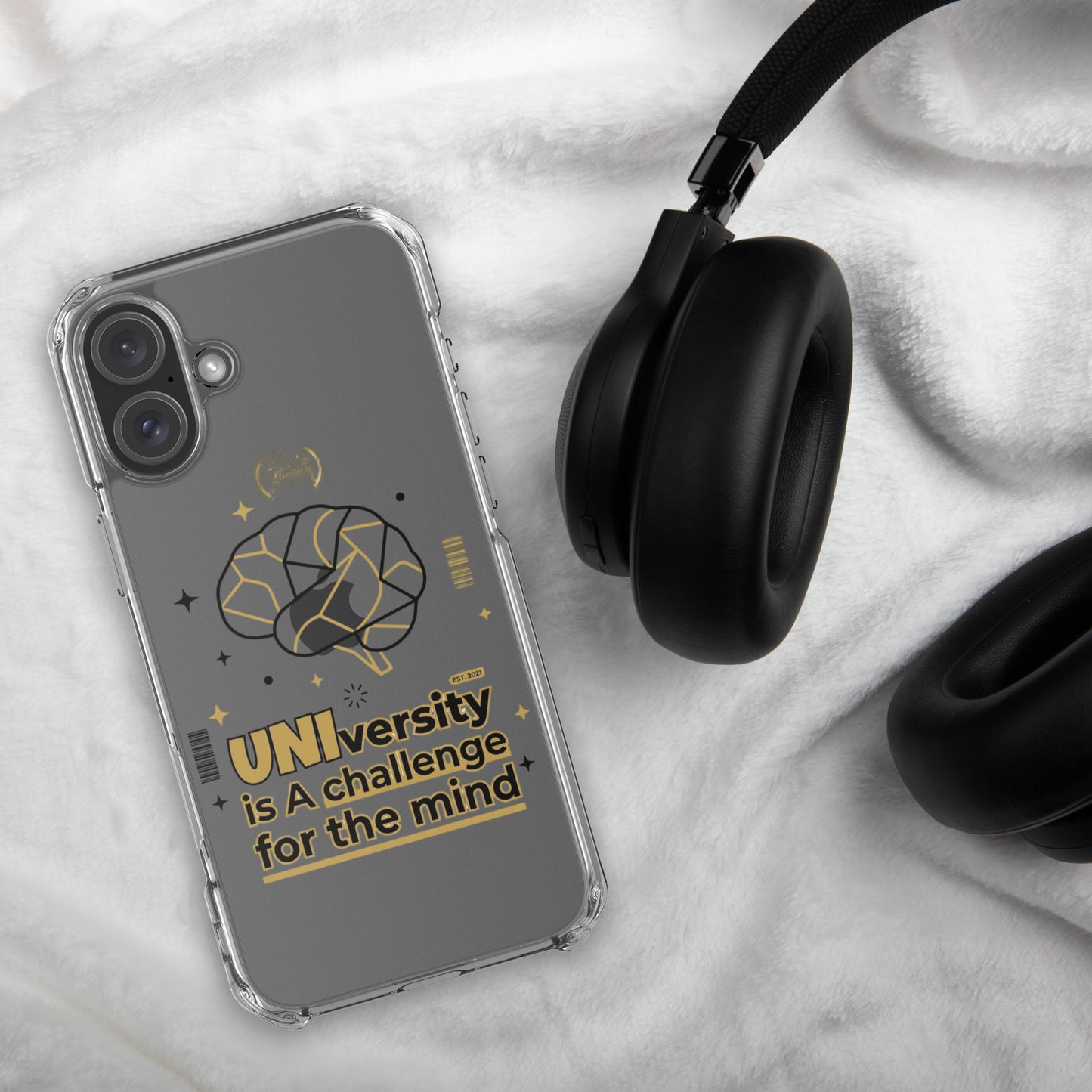 Phone case with text and design on a marble surface with headphones