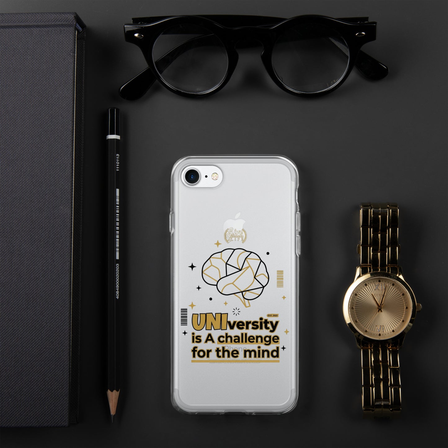 Phone case with brain design and text, placed on a dark surface with glasses, pen, and watch.