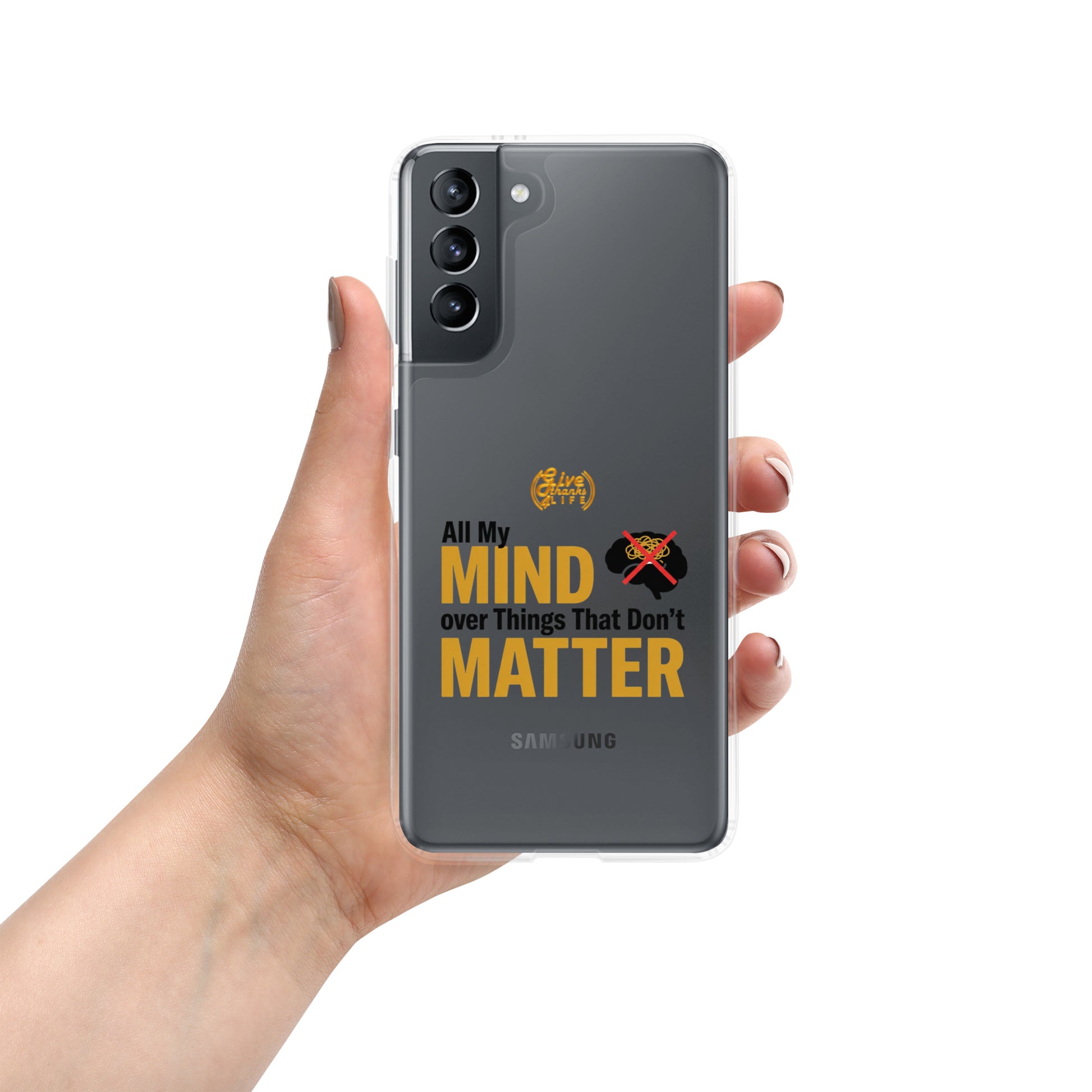 Hand holding a Samsung phone with a motivational quote on the case