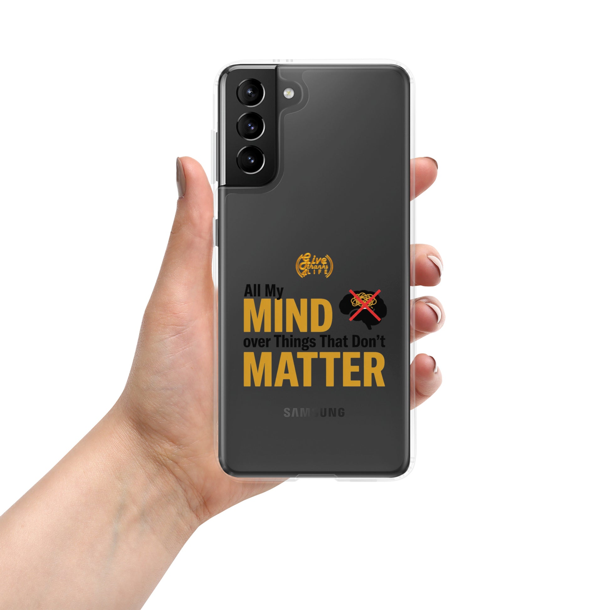 Hand holding a Samsung phone with a motivational quote on the case