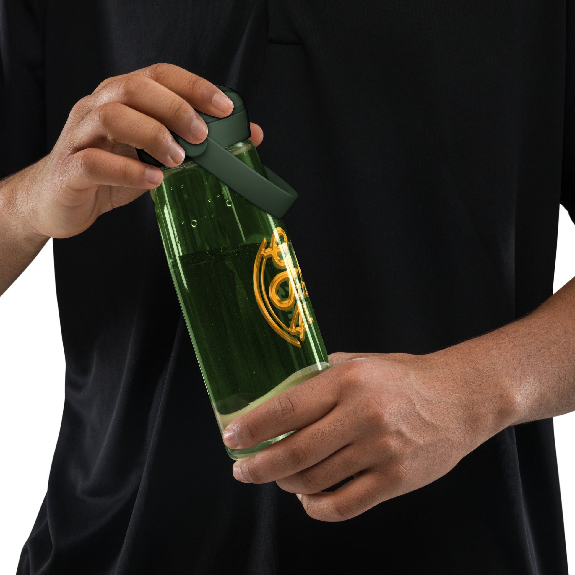 Person opening a green bottle with a black cap against a black background