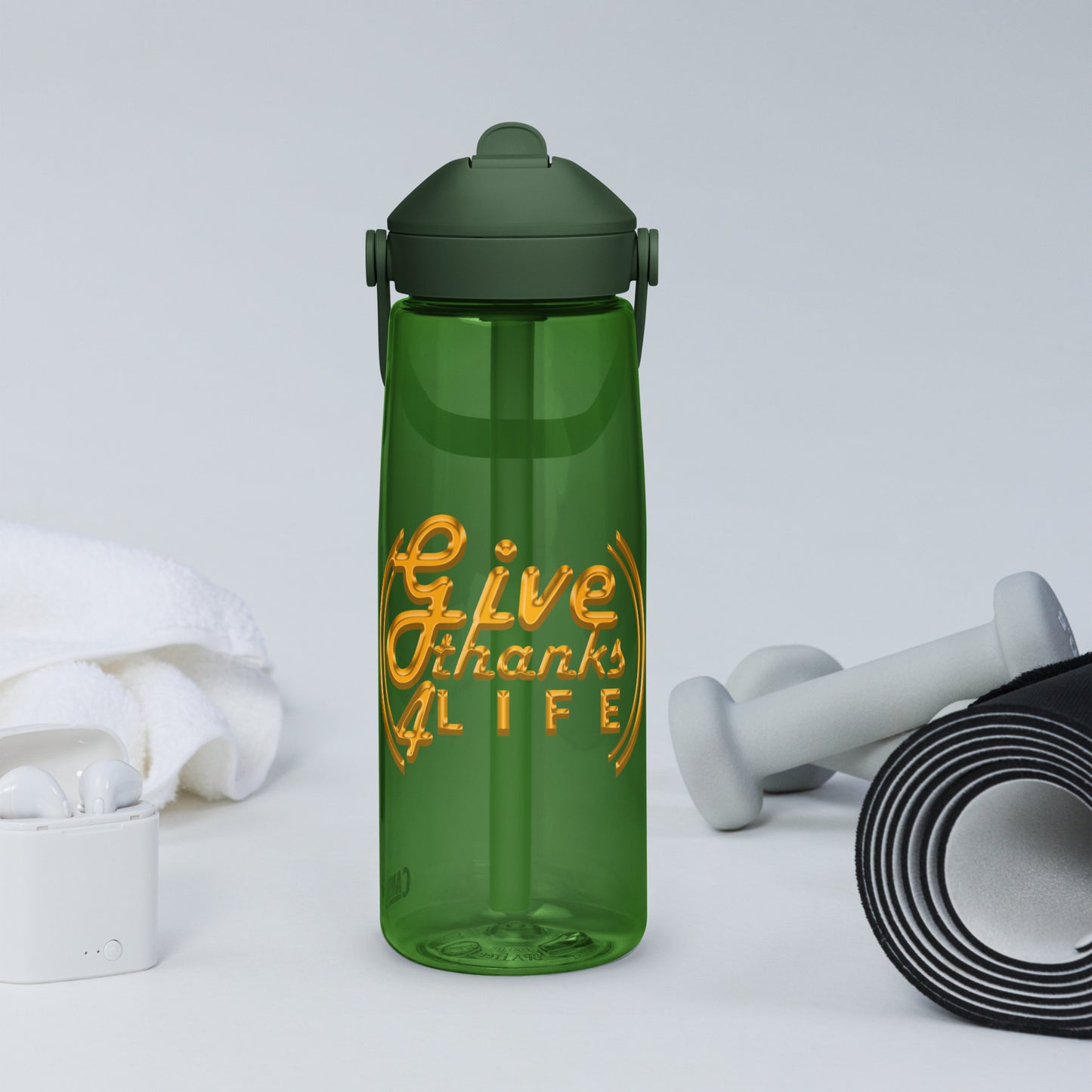 Green water bottle with 'Give Thanks Life' text, dumbbells, and earbuds on a light gray background