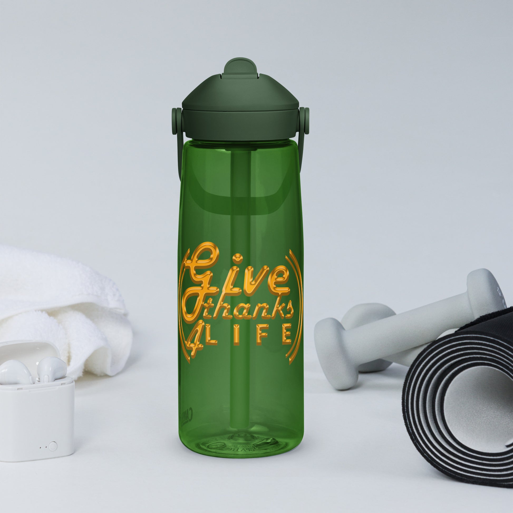 Green water bottle with 'Give Thanks Life' text, dumbbells, and earbuds on a light gray background