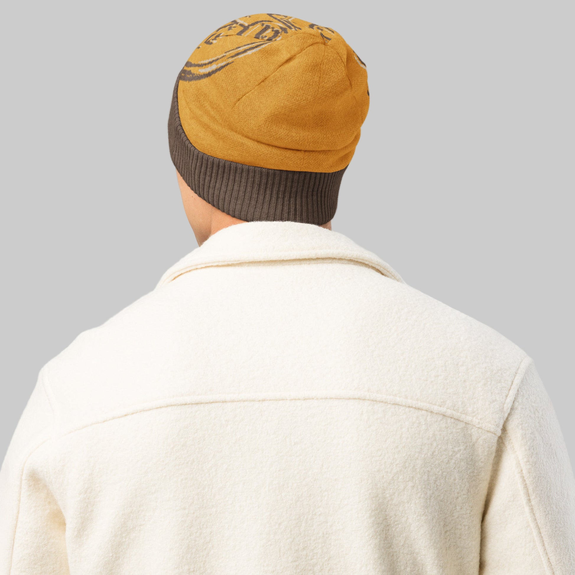 Person wearing a beige beanie with a brown interior on a white background
