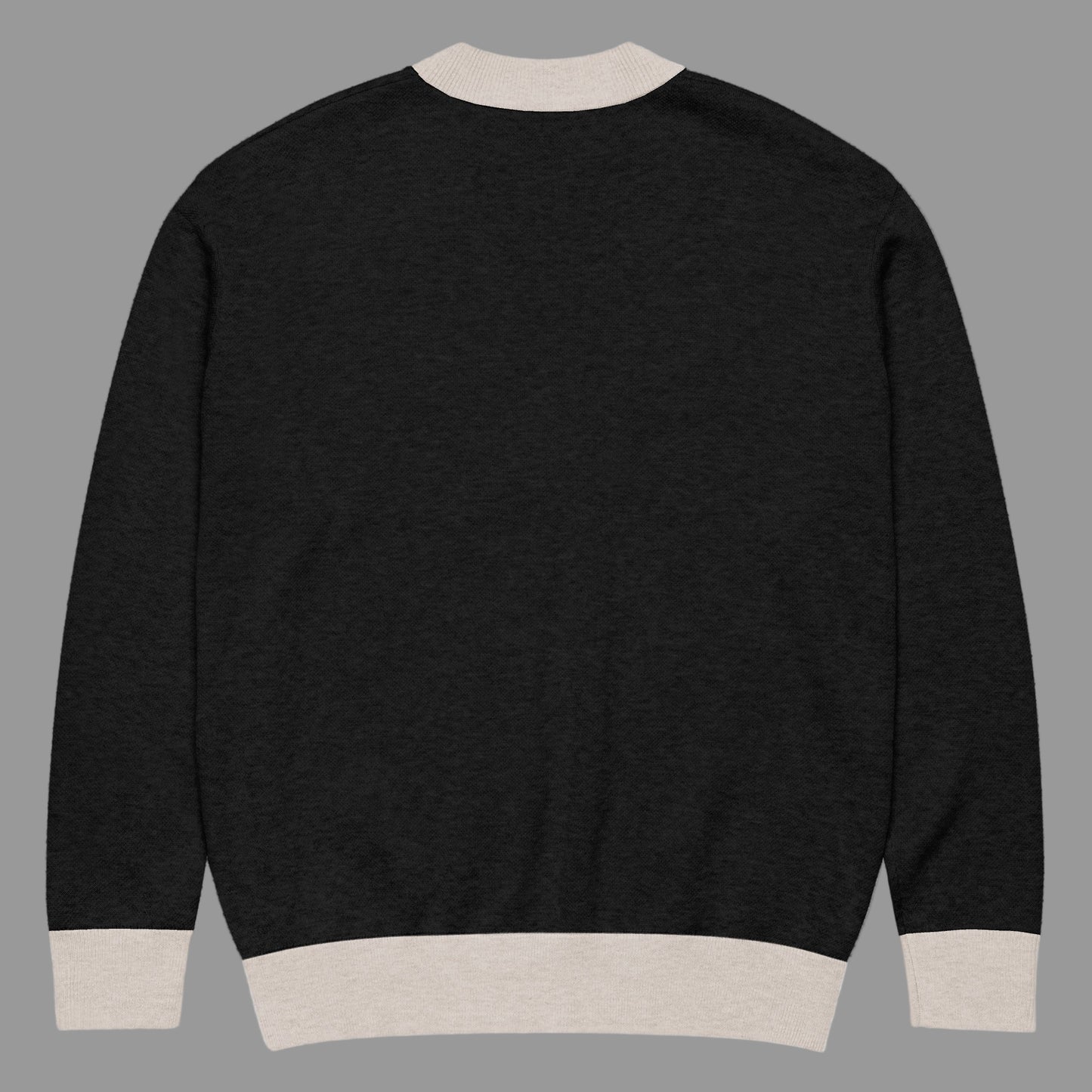 Black sweater with beige trim on a white background