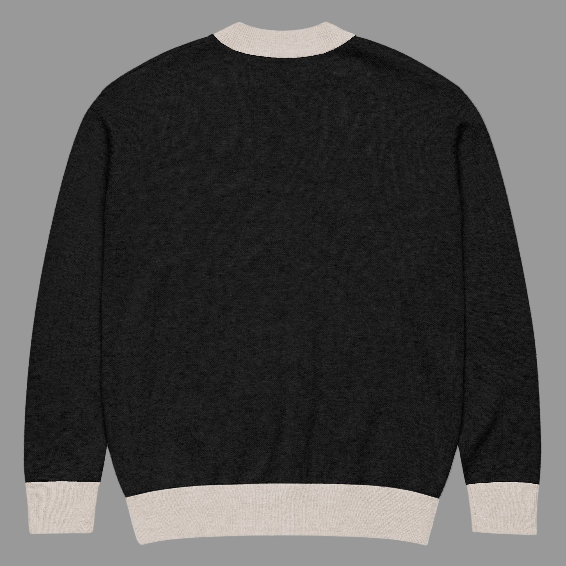 Black sweater with beige trim on a white background