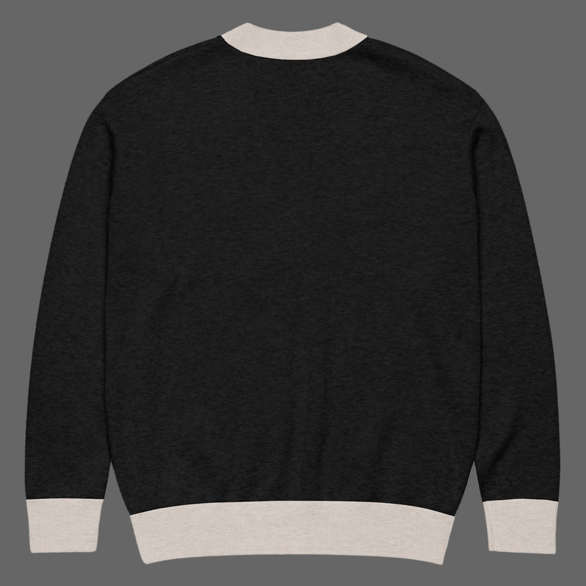 Black sweater with beige trim on a white background