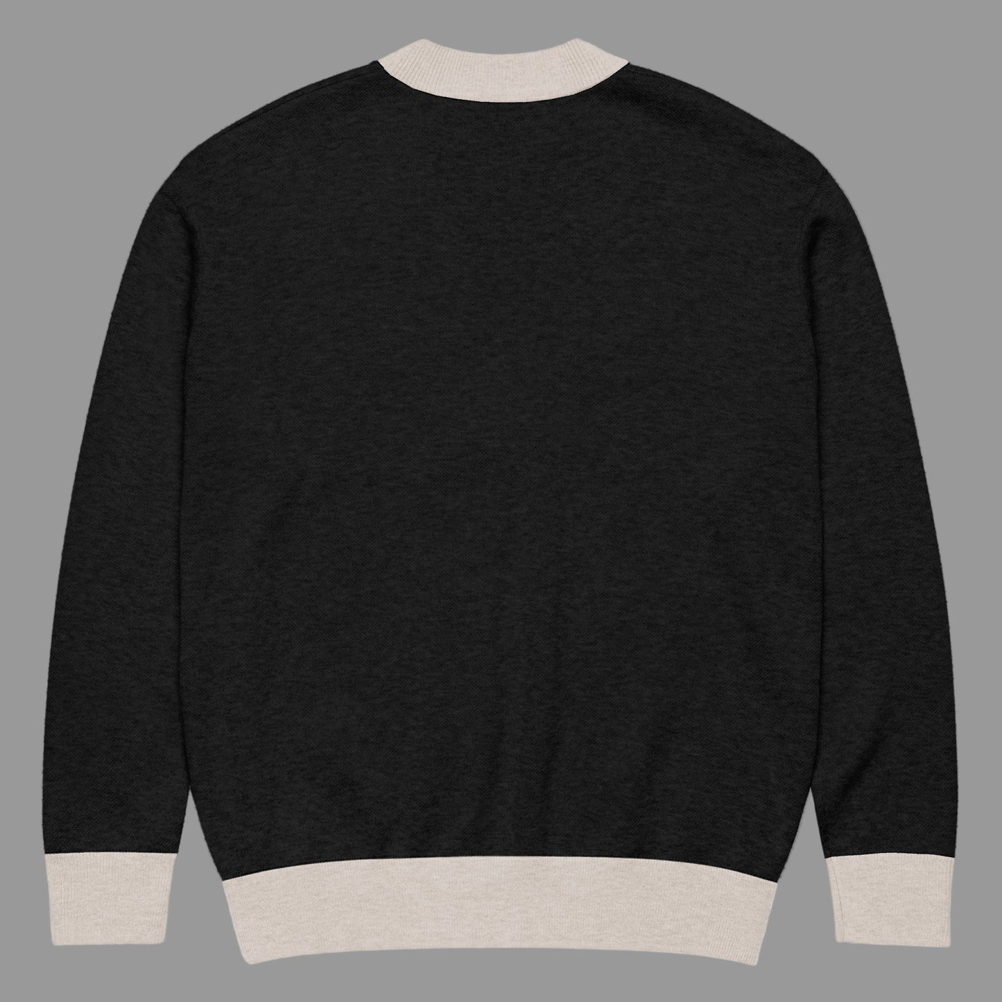 Black sweater with beige trim on a white background